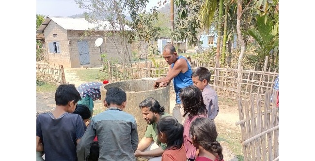 Dr Jagannath Biswakarma helping children understand the groundwater quality in his hometown Assam, India.